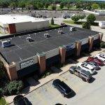 top down view of business strip mall with parking lot